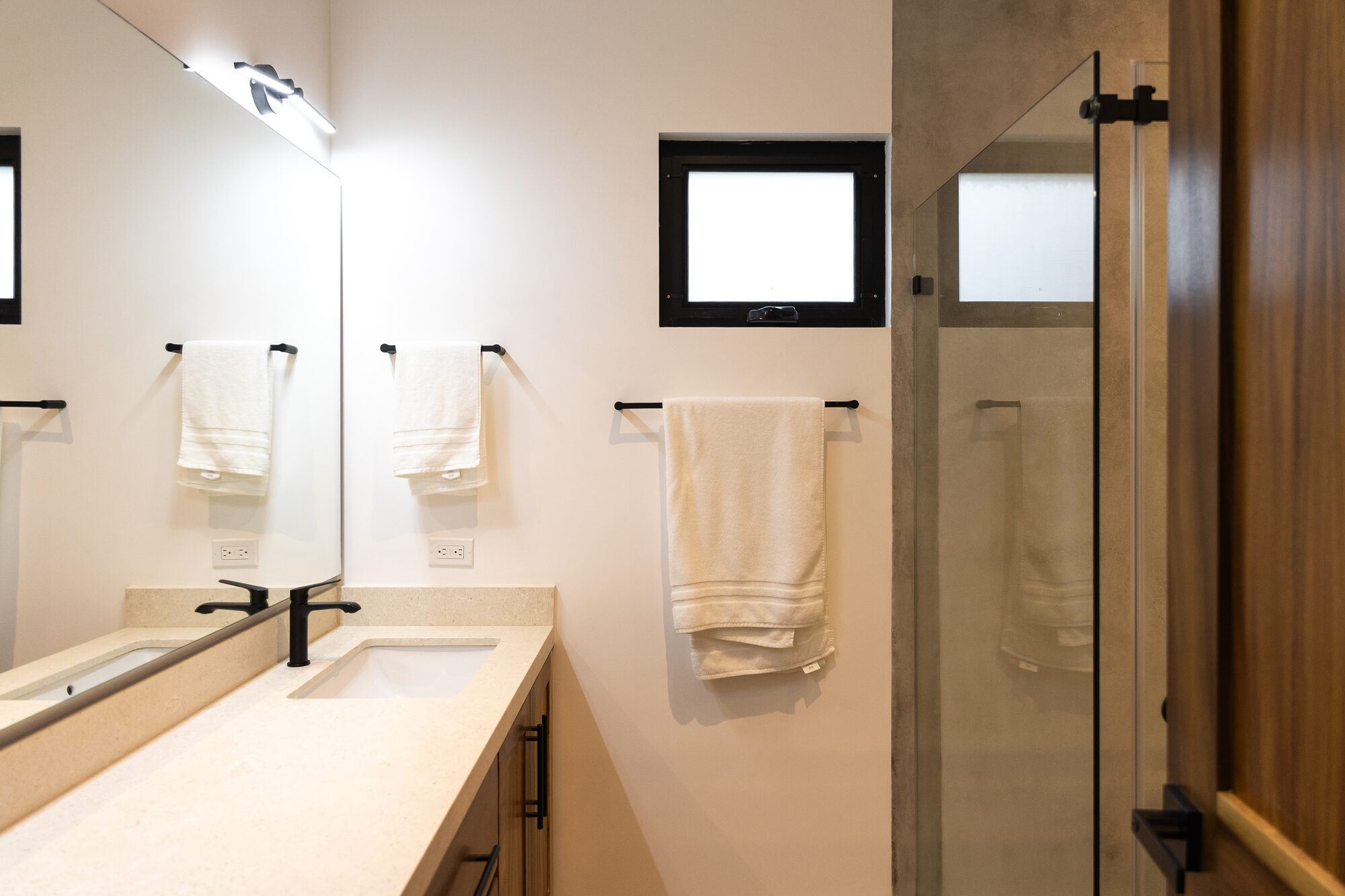 A stone bathroom sink with a mirror above it