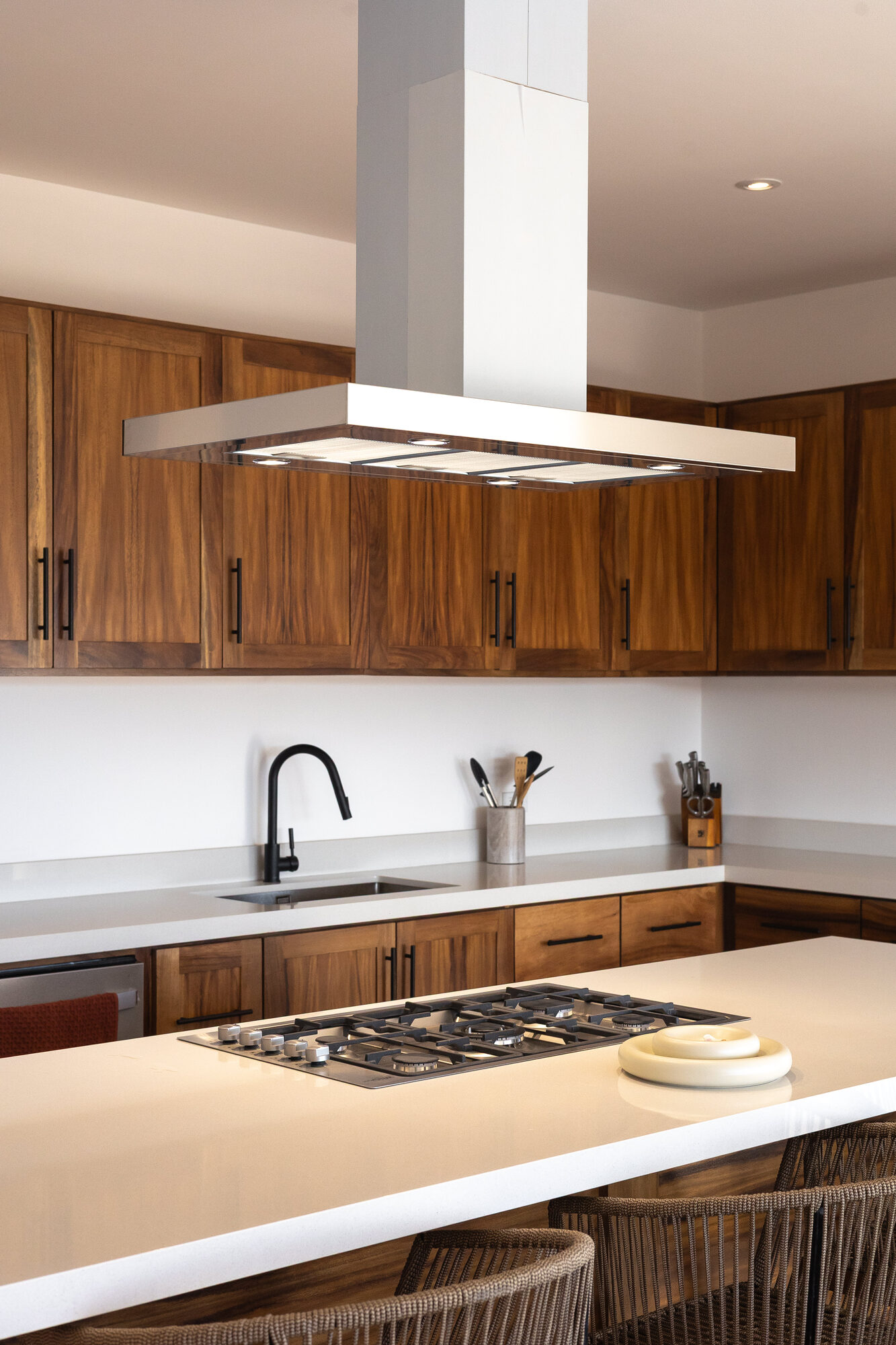 Open kitchen cabinets holding plates, glasses and bowls
