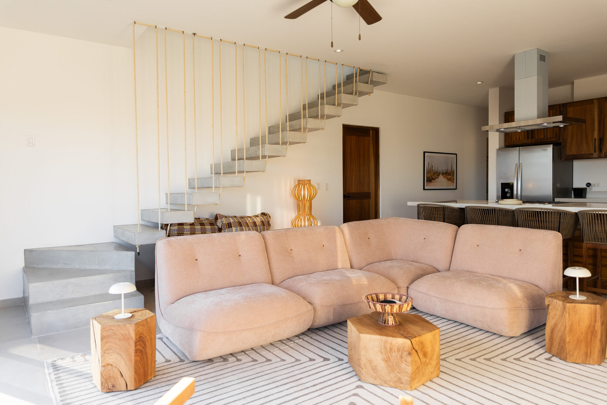 The living room seen from the stair, sofa and open floor below